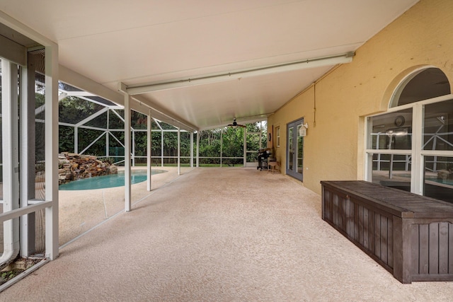 view of patio with an outdoor pool and glass enclosure