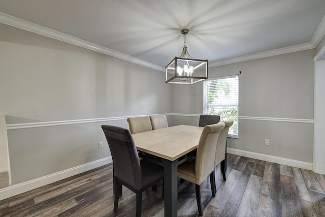 dining area with dark wood finished floors, baseboards, ornamental molding, and a notable chandelier