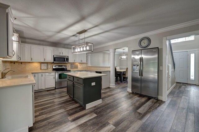 kitchen featuring white cabinetry, crown molding, a sink, stainless steel appliances, and light countertops