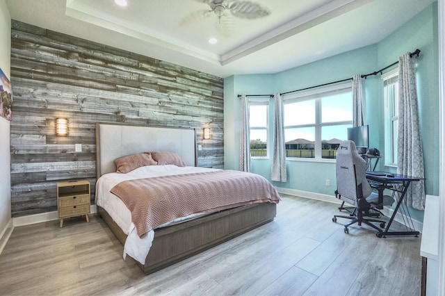 15581 Goldfinch Cir, The Acreage, FL 33470 - bedroom featuring an accent wall, wooden walls, baseboards, recessed lighting, and wood finished floors