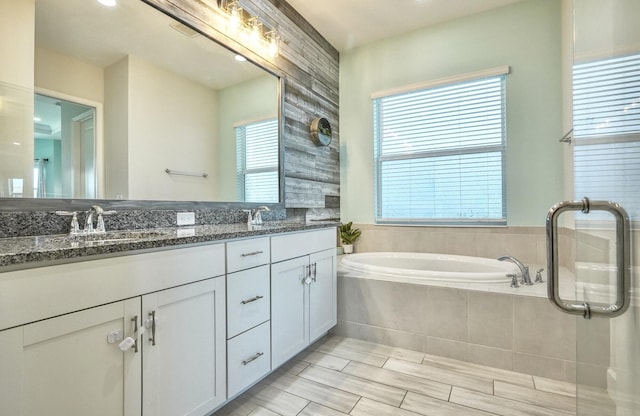15581 Goldfinch Cir, The Acreage, FL 33470 - bathroom featuring a garden tub and double vanity