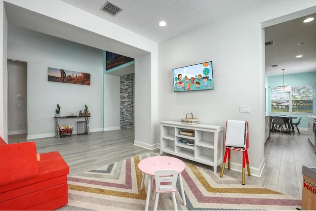 15581 Goldfinch Cir, The Acreage, FL 33470 - living room with wood finished floors, baseboards, and recessed lighting