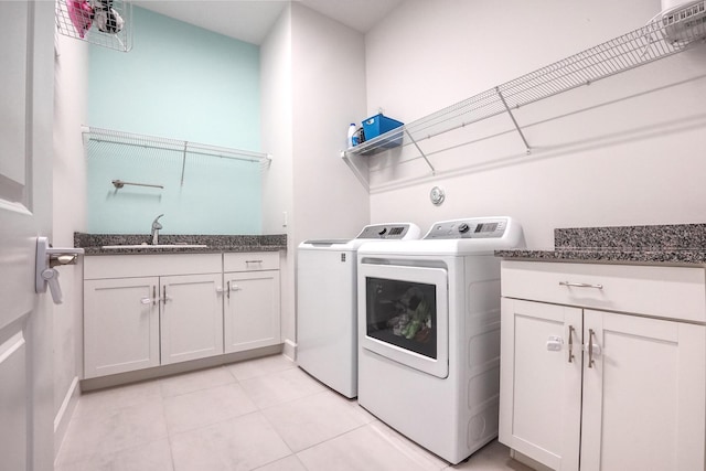 15581 Goldfinch Cir, The Acreage, FL 33470 - laundry area with washing machine and clothes dryer, cabinet space, light tile patterned floors, and baseboards