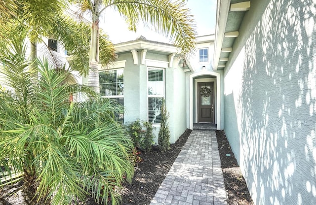 15581 Goldfinch Cir, The Acreage, FL 33470 - view of exterior entry featuring stucco siding
