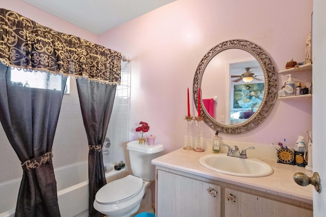 bathroom featuring toilet, a ceiling fan, shower / bath combo with shower curtain, and vanity