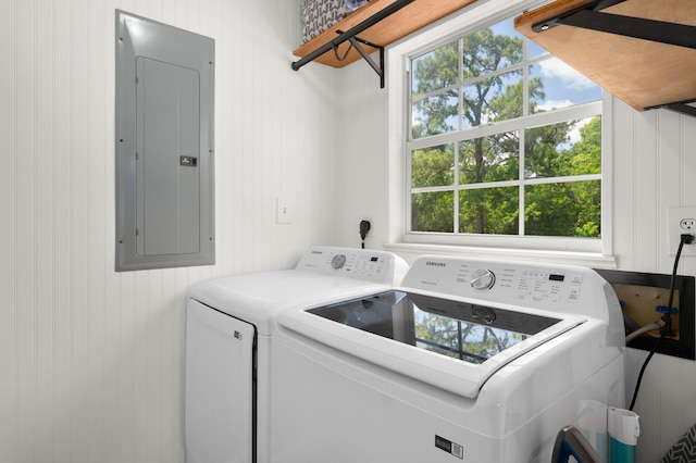 laundry room with electric panel, washer and dryer, and laundry area