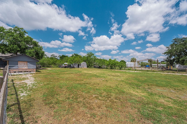 view of yard featuring fence and an outdoor structure