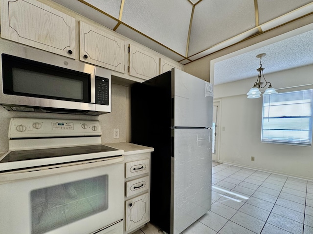 82 Dorset Unit B, Boca Raton, FL 33434 - kitchen featuring white range with electric cooktop, stainless steel microwave, freestanding refrigerator, light tile patterned floors, and light countertops