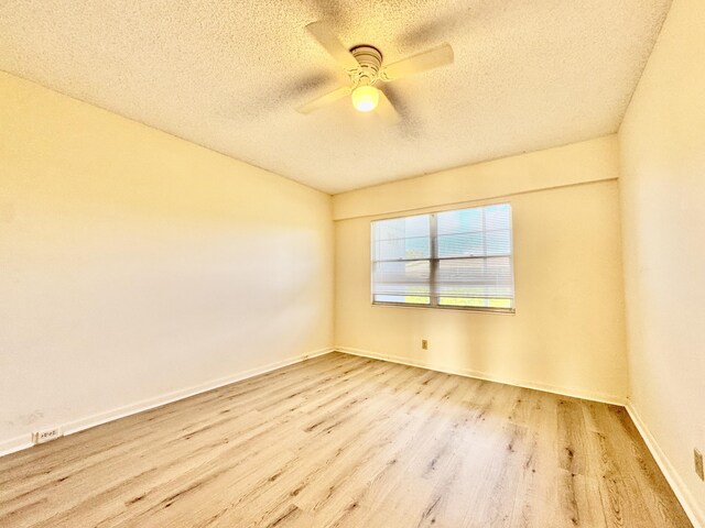 82 Dorset Unit B, Boca Raton, FL 33434 - empty room with a textured ceiling, wood finished floors, and ceiling fan