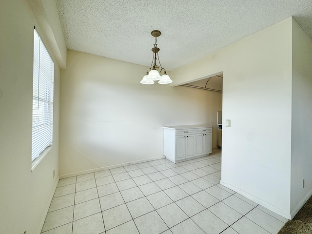 82 Dorset Unit B, Boca Raton, FL 33434 - spare room with a textured ceiling and light tile patterned floors