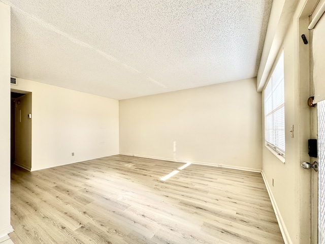 82 Dorset Unit B, Boca Raton, FL 33434 - empty room with light wood-style flooring and a textured ceiling