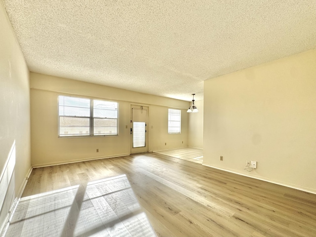 82 Dorset Unit B, Boca Raton, FL 33434 - unfurnished living room featuring wood finished floors and a textured ceiling