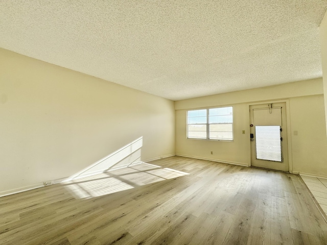 82 Dorset Unit B, Boca Raton, FL 33434 - unfurnished living room with wood finished floors and a textured ceiling