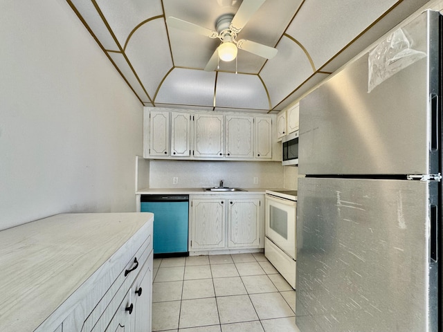 82 Dorset Unit B, Boca Raton, FL 33434 - kitchen featuring stainless steel appliances, light countertops, light tile patterned flooring, a ceiling fan, and white cabinetry