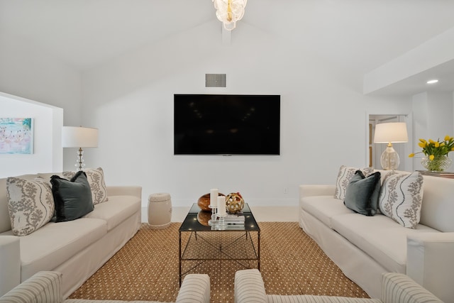 carpeted living area with baseboards, visible vents, ceiling fan, and lofted ceiling