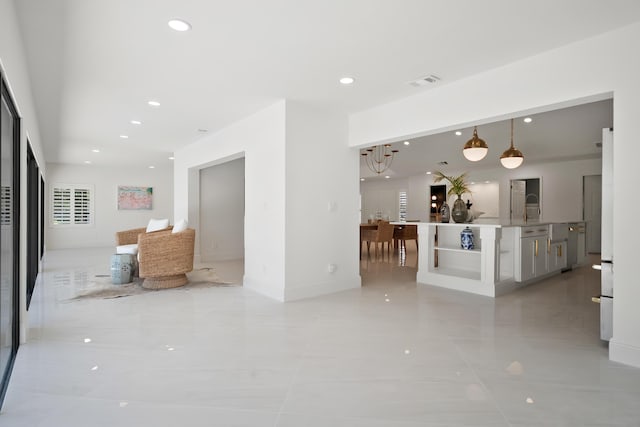 unfurnished living room featuring light tile patterned floors, visible vents, and recessed lighting