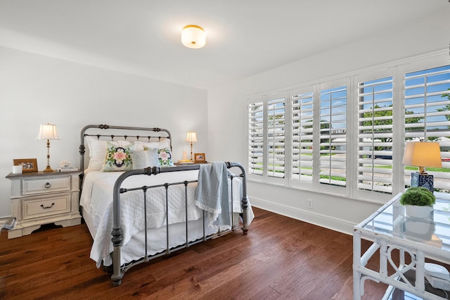 bedroom with baseboards and wood finished floors