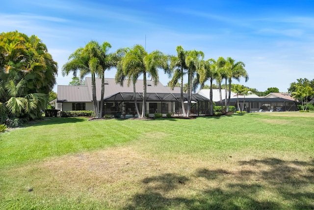 view of yard with glass enclosure