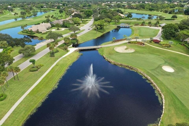 birds eye view of property featuring a water view and view of golf course