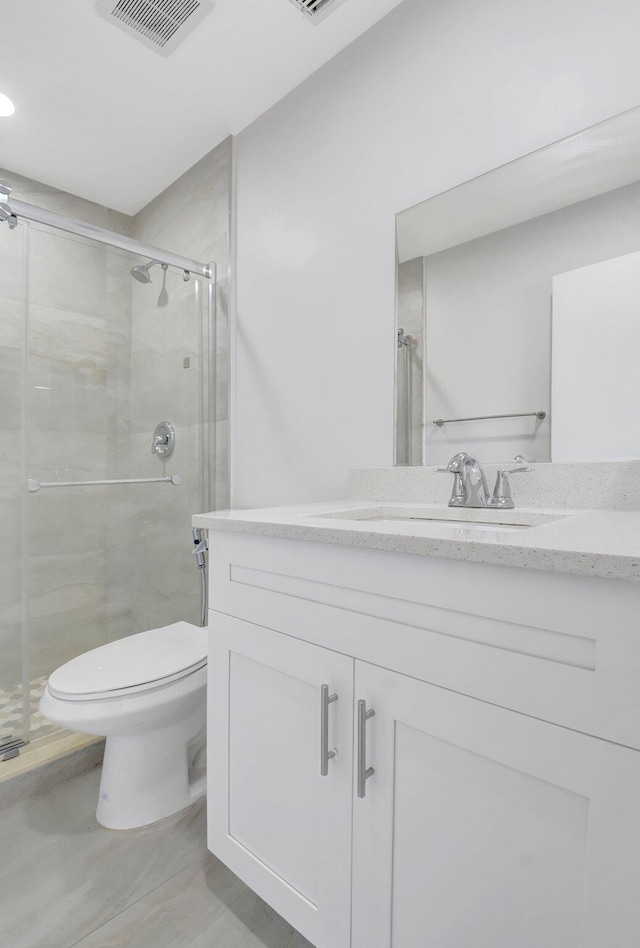 full bath with visible vents, a stall shower, toilet, and vanity
