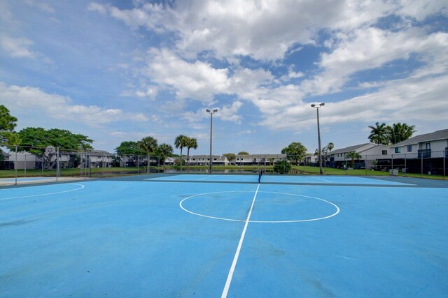 view of sport court with fence, a residential view, and community basketball court