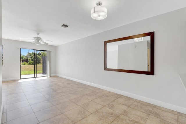 unfurnished room featuring baseboards, visible vents, light tile patterned floors, and a ceiling fan
