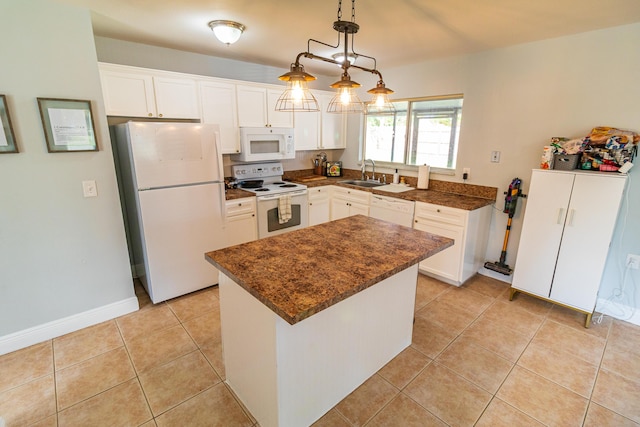 kitchen featuring light tile patterned floors, a sink, white cabinetry, and white appliances