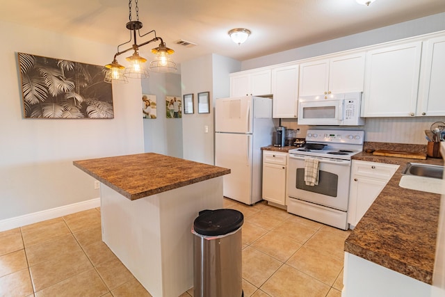 kitchen with light tile patterned flooring, visible vents, white cabinetry, white appliances, and dark countertops