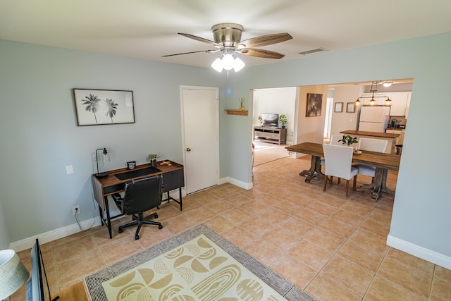 office space with light tile patterned floors, visible vents, ceiling fan, and baseboards
