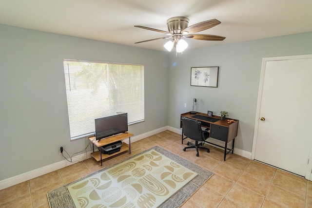 home office with light tile patterned floors, a ceiling fan, and baseboards