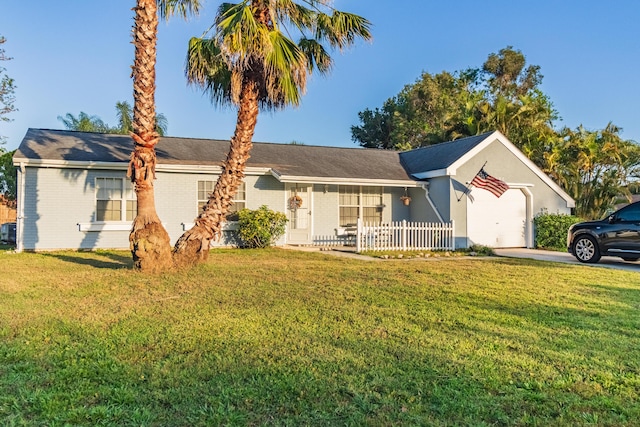 single story home with brick siding, a front lawn, and concrete driveway