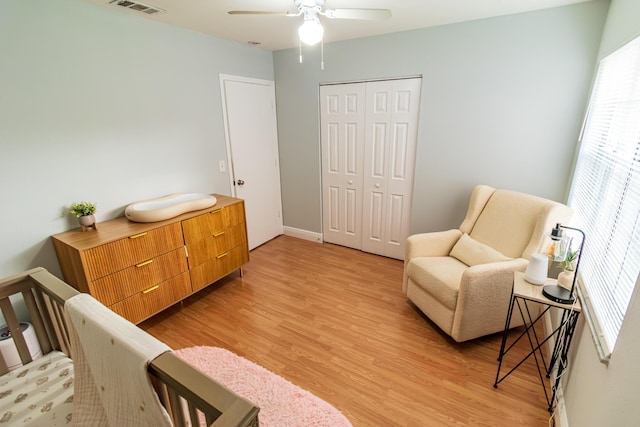 living area with visible vents, a ceiling fan, and light wood-style floors