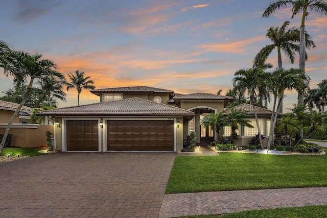 6616 Cobia Cir, Boynton Beach, FL 33437 - mediterranean / spanish-style house with decorative driveway, a garage, a tile roof, stucco siding, and a front yard