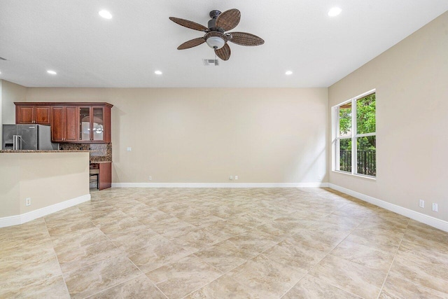 unfurnished living room featuring ceiling fan, visible vents, baseboards, light tile patterned flooring, and recessed lighting