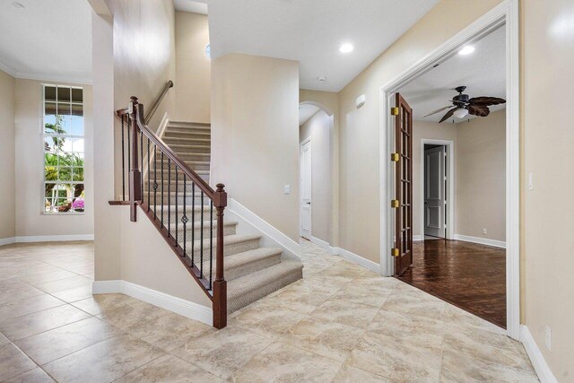 6616 Cobia Cir, Boynton Beach, FL 33437 - stairway featuring arched walkways, ceiling fan, and baseboards