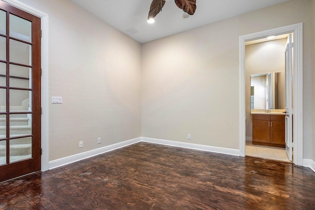 unfurnished room with baseboards, visible vents, a ceiling fan, and light wood-style flooring