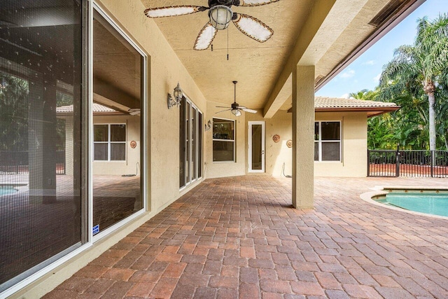 view of patio / terrace featuring a fenced in pool, ceiling fan, and fence
