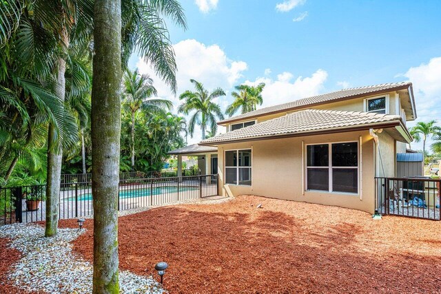 6616 Cobia Cir, Boynton Beach, FL 33437 - back of property with a tile roof, stucco siding, and a patio area