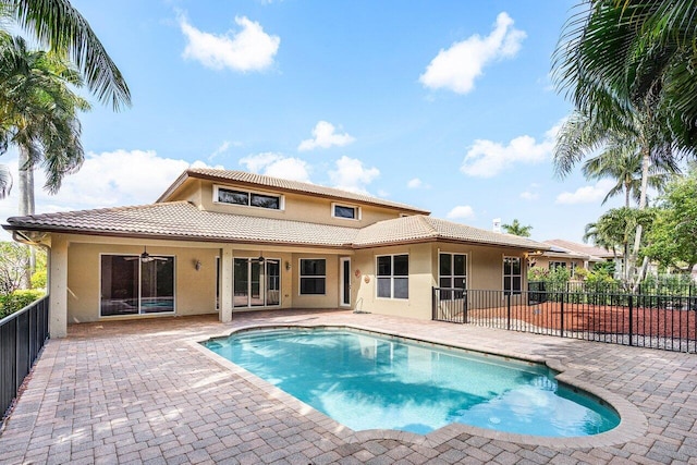 view of swimming pool with fence, ceiling fan, a patio area, and a fenced in pool