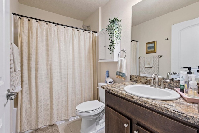 full bathroom with toilet, tile patterned flooring, and vanity