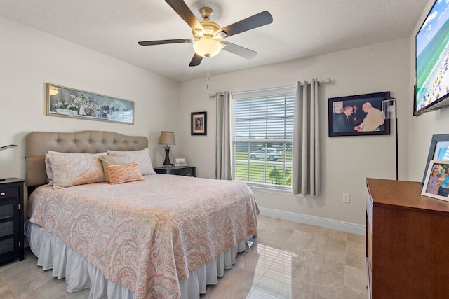 bedroom with baseboards and a ceiling fan