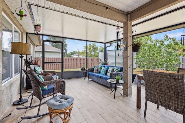 sunroom / solarium with an outdoor living space and plenty of natural light