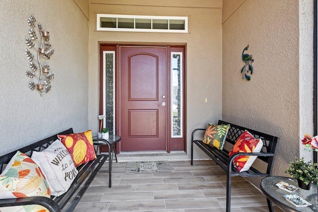 entrance to property featuring stucco siding