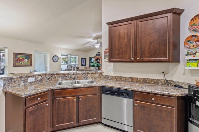 kitchen featuring light stone countertops, stainless steel dishwasher, ceiling fan, a sink, and a peninsula