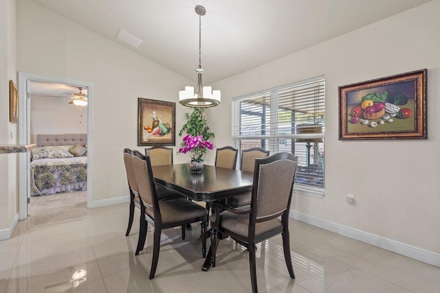 dining area featuring baseboards, light tile patterned floors, and lofted ceiling