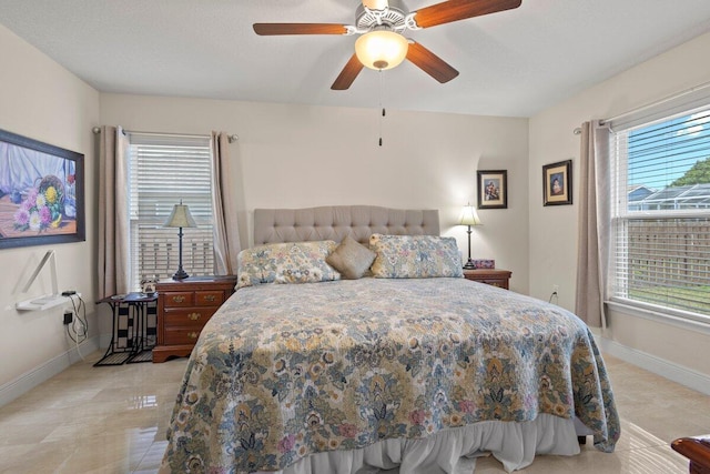 bedroom featuring baseboards and ceiling fan