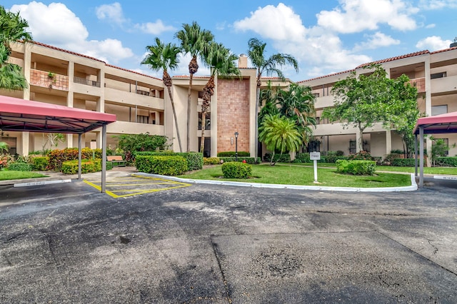7460 La Paz Blvd Unit 206, Boca Raton, FL 33433 - view of building exterior with covered and uncovered parking