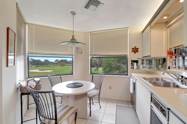 7460 La Paz Blvd Unit 206, Boca Raton, FL 33433 - kitchen featuring hanging light fixtures, light tile patterned floors, light countertops, a sink, and visible vents
