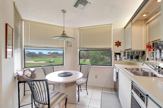 7460 La Paz Blvd Unit 206, Boca Raton, FL 33433 - kitchen featuring light tile patterned floors, a sink, visible vents, light countertops, and decorative light fixtures