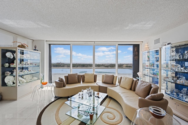 525 S Flagler Dr Unit 16A, West Palm Beach, FL 33401 - living area with a water view, tile patterned floors, a textured ceiling, and visible vents